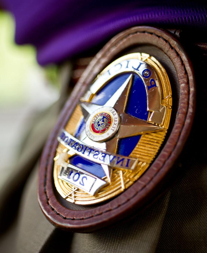 Police officer badge on a belt.