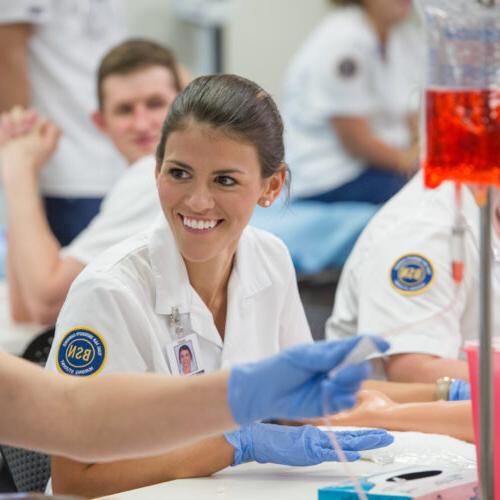 Nursing student smiling while learning.