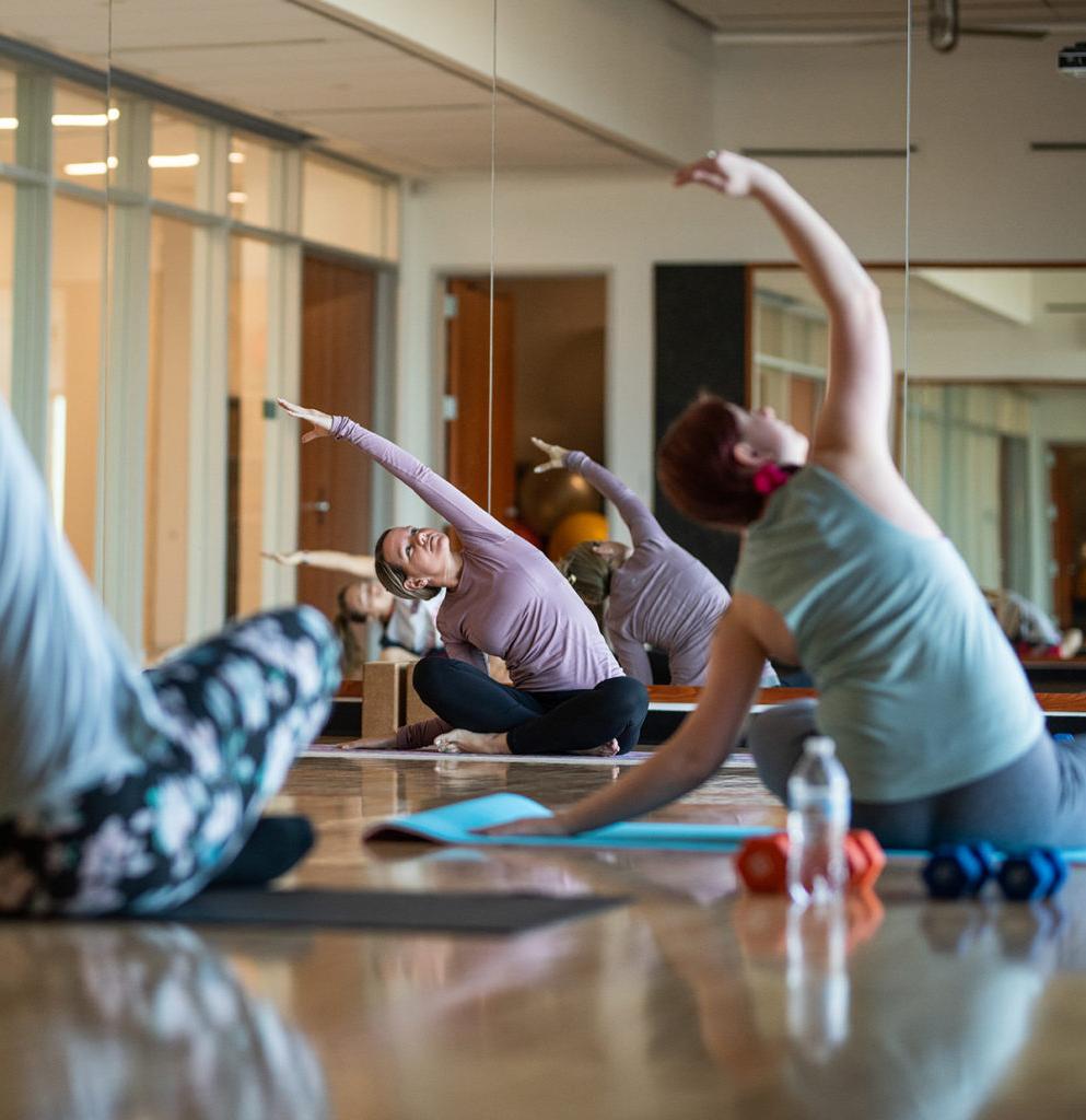 Students during a yoga session inside the nursing and health sciences building.