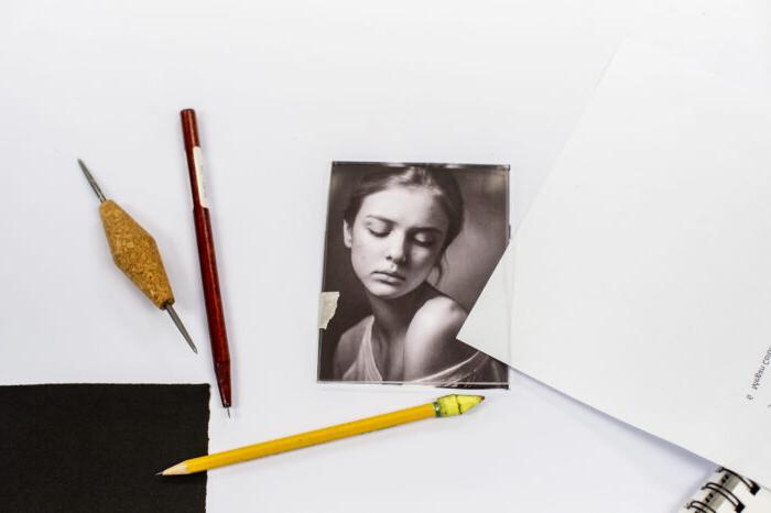 Photography portrait on table with art supplies.